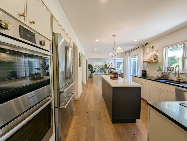 1 Concord Dr, Fort Salonga, NY 11768 - kitchen featuring stainless steel appliances, a sink, a center island, light wood-type flooring, and recessed lighting