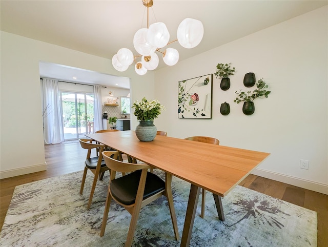 1 Concord Dr, Fort Salonga, NY 11768 - dining space featuring a chandelier, wood finished floors, and baseboards