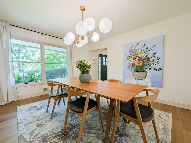 1 Concord Dr, Fort Salonga, NY 11768 - dining area featuring baseboards, wood finished floors, and a chandelier