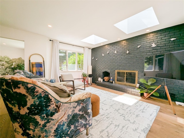 1 Concord Dr, Fort Salonga, NY 11768 - living room with a skylight, wood finished floors, a brick fireplace, recessed lighting, and brick wall