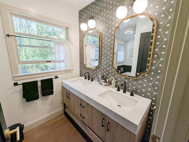 1 Concord Dr, Fort Salonga, NY 11768 - bathroom with wallpapered walls, wood finished floors, baseboards, and double vanity