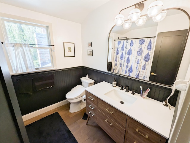 1 Concord Dr, Fort Salonga, NY 11768 - bathroom featuring wainscoting, toilet, vanity, wood finished floors, and vaulted ceiling