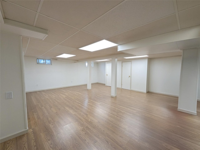 1 Concord Dr, Fort Salonga, NY 11768 - basement with light wood-style flooring, a drop ceiling, and baseboards