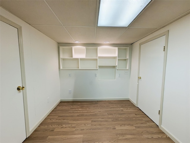 1 Concord Dr, Fort Salonga, NY 11768 - empty room with a drop ceiling, wood finished floors, and baseboards