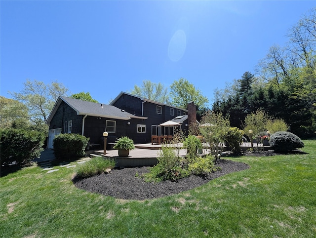 1 Concord Dr, Fort Salonga, NY 11768 - back of property with a wooden deck, a yard, and a chimney
