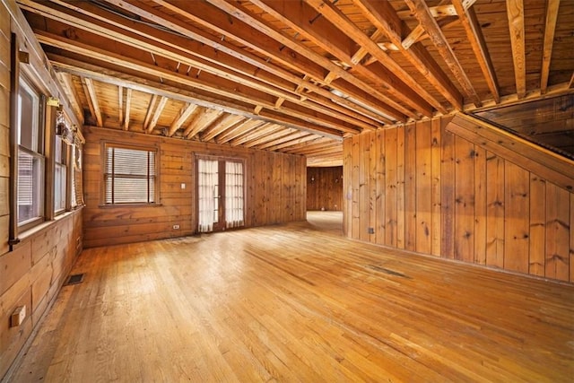 interior space featuring visible vents, wood walls, french doors, and wood-type flooring