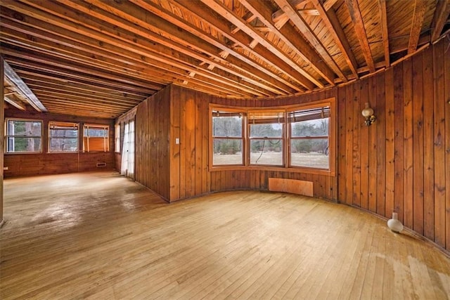 misc room with wood walls and hardwood / wood-style floors