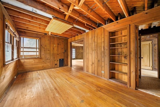 interior space with wood walls and hardwood / wood-style flooring