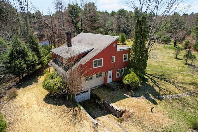 birds eye view of property featuring a wooded view