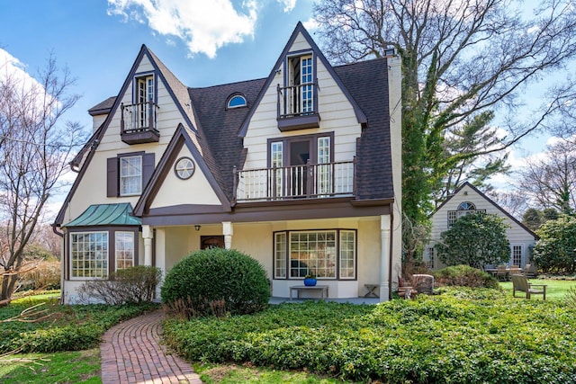 3 Wincoma Dr, Huntington Bay, NY 11743 - tudor house with a chimney, a balcony, a shingled roof, and stucco siding