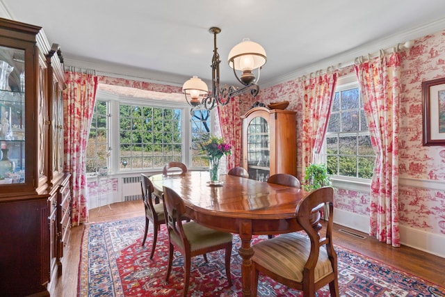 3 Wincoma Dr, Huntington Bay, NY 11743 - dining room featuring baseboards, wallpapered walls, radiator heating unit, wood finished floors, and an inviting chandelier