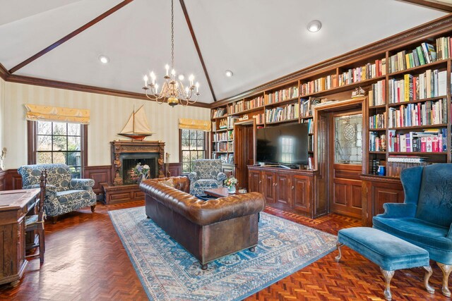 3 Wincoma Dr, Huntington Bay, NY 11743 - living area with a wainscoted wall, a chandelier, ornamental molding, built in shelves, and vaulted ceiling