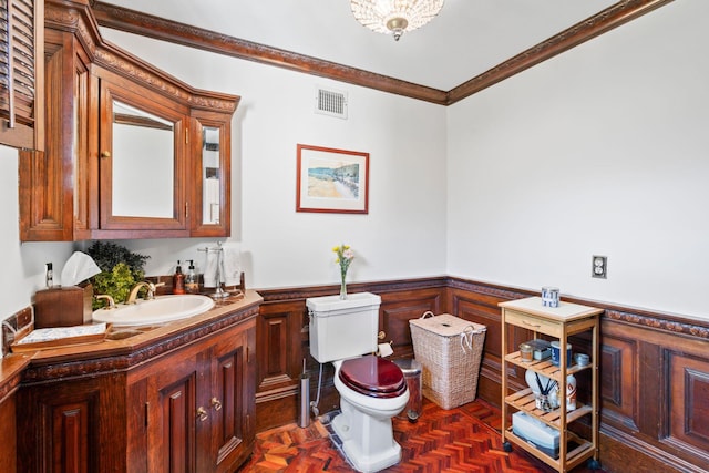 3 Wincoma Dr, Huntington Bay, NY 11743 - bathroom featuring a wainscoted wall, visible vents, ornamental molding, toilet, and vanity