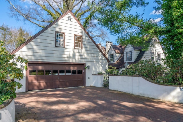 3 Wincoma Dr, Huntington Bay, NY 11743 - view of side of property with decorative driveway and an attached garage