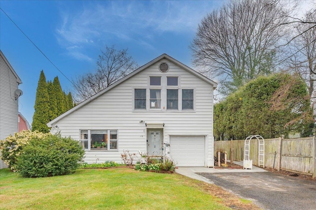 view of front of property featuring a garage, aphalt driveway, fence, and a front lawn