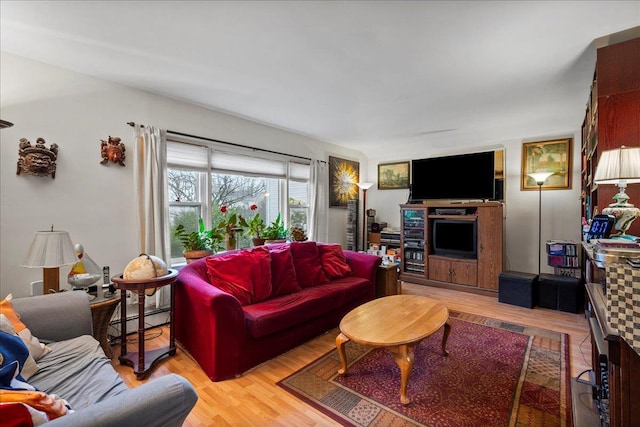 living area featuring baseboard heating and light wood-type flooring