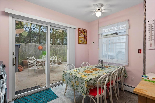 dining area with a ceiling fan and a baseboard heating unit