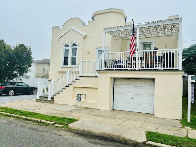 105 Mitchell Ave, Long Beach, NY 11561 - townhome / multi-family property featuring stucco siding, an attached garage, and driveway