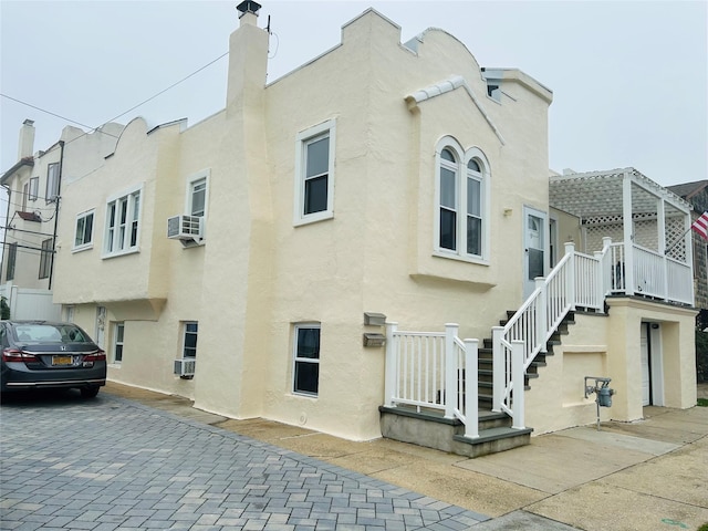 105 Mitchell Ave, Long Beach, NY 11561 - view of home's exterior featuring stucco siding and stairway