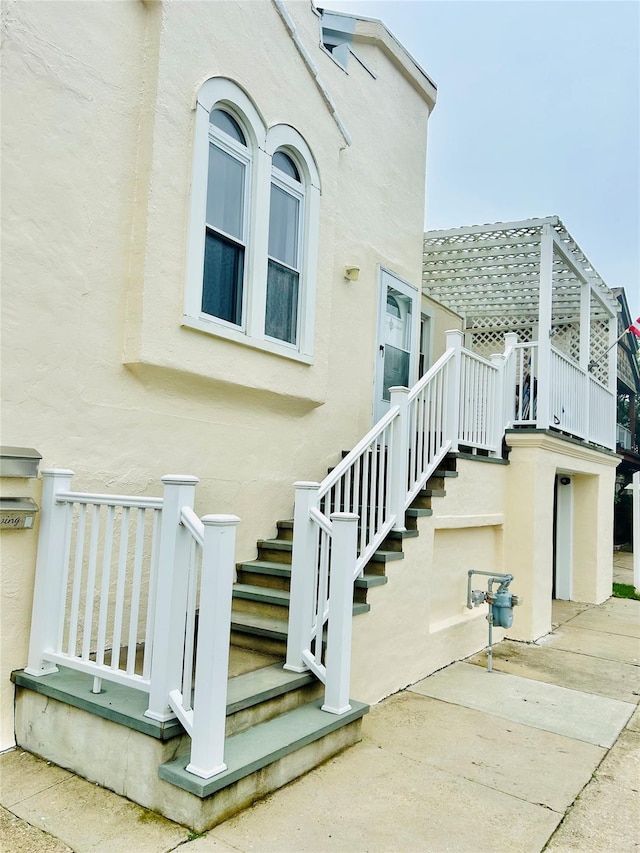 105 Mitchell Ave, Long Beach, NY 11561 - view of exterior entry with stucco siding and a patio