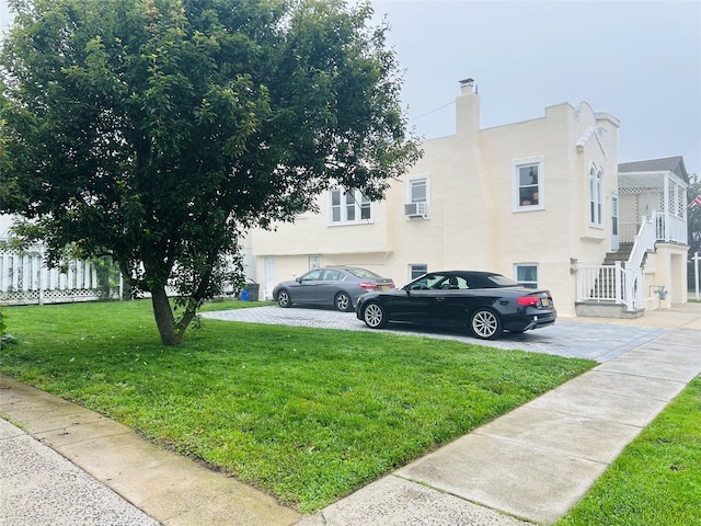 105 Mitchell Ave, Long Beach, NY 11561 - view of home's exterior with stucco siding and stairway