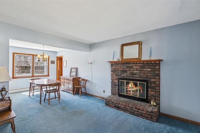 carpeted dining room with a chandelier, a brick fireplace, baseboards, and a baseboard heating unit