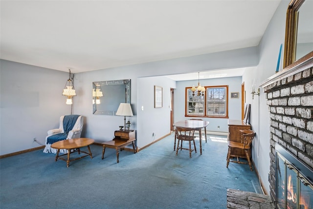 sitting room featuring carpet flooring, a notable chandelier, baseboards, and a fireplace