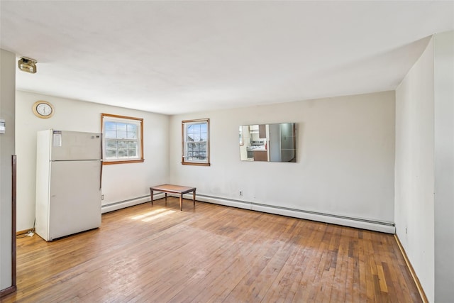 unfurnished room with wood-type flooring and baseboards