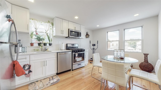 138-07 232nd St, Laurelton, NY 11413 - kitchen featuring a sink, appliances with stainless steel finishes, plenty of natural light, and light wood-style floors