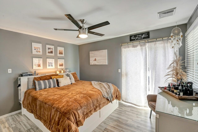 bedroom with access to outside, visible vents, light wood-type flooring, and a ceiling fan