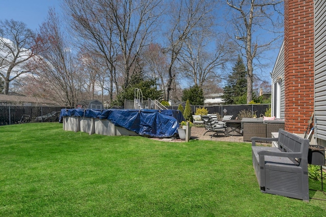 view of yard featuring a fenced in pool, a patio area, and fence