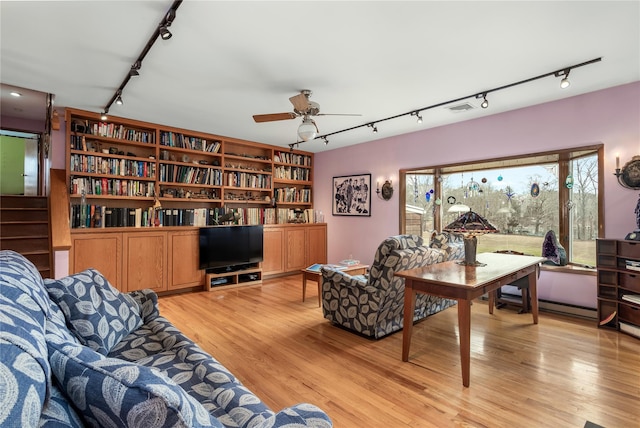 living room featuring track lighting, light wood-style flooring, and ceiling fan