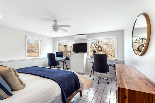 bedroom featuring a wall mounted air conditioner, light tile patterned floors, an office area, and ceiling fan