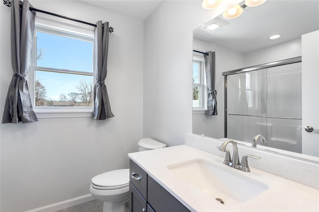 full bath with a shower with shower door, toilet, vanity, and baseboards