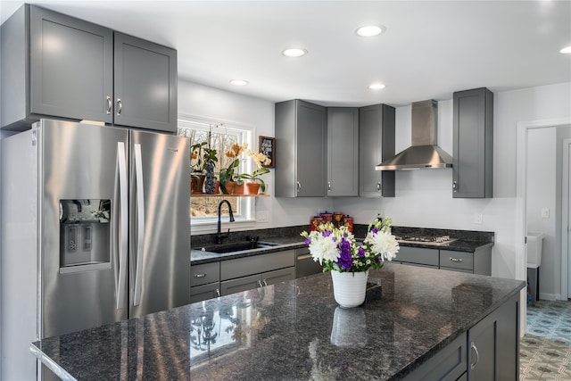 kitchen with appliances with stainless steel finishes, wall chimney exhaust hood, a sink, gray cabinetry, and recessed lighting