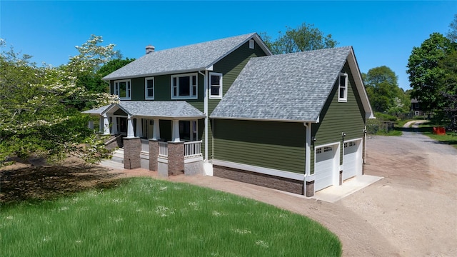 view of front of property featuring a porch, a shingled roof, an attached garage, driveway, and a chimney