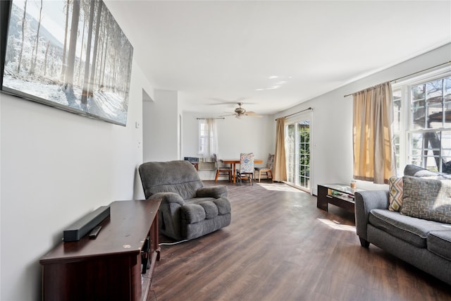 living room featuring dark wood finished floors and ceiling fan
