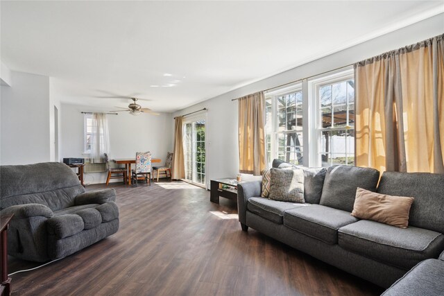 living room with a ceiling fan and dark wood-style flooring