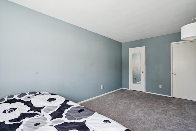 carpeted bedroom featuring baseboards