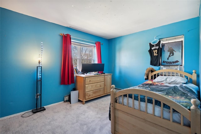 carpeted bedroom featuring baseboards
