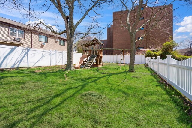 view of yard with a fenced backyard and a playground
