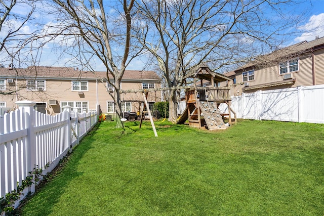 view of yard with a fenced backyard, a residential view, and a playground