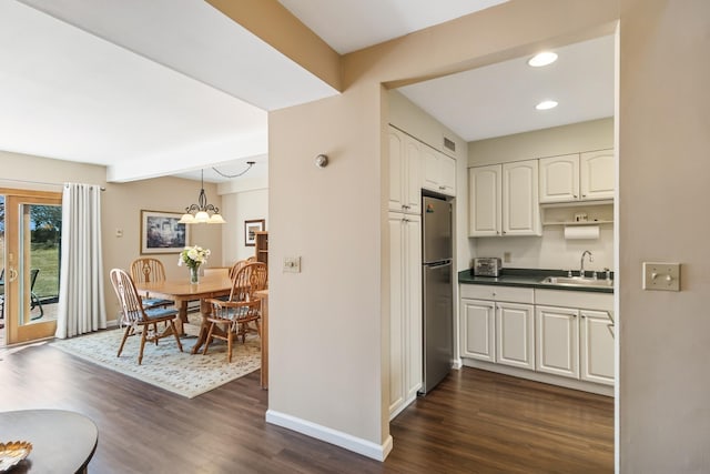29 Fairway Pl Unit 14, Montauk, NY 11954 - kitchen with a sink, freestanding refrigerator, baseboards, and dark wood-style floors