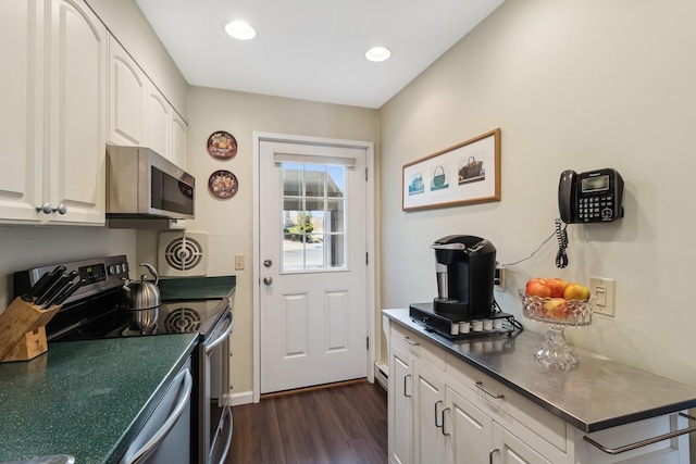 29 Fairway Pl Unit 14, Montauk, NY 11954 - kitchen with recessed lighting, baseboards, white cabinetry, appliances with stainless steel finishes, and dark wood-style floors