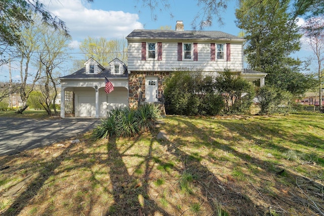 12 Sunset View Dr, West Nyack, NY 10994 - view of front facade with a front yard, a chimney, a garage, and aphalt driveway
