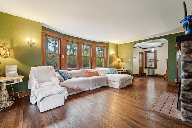 12 Sunset View Dr, West Nyack, NY 10994 - living area featuring arched walkways, wood finished floors, radiator heating unit, and baseboards