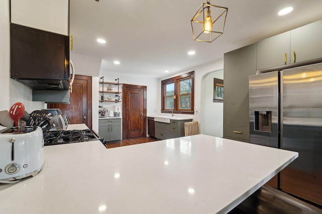 12 Sunset View Dr, West Nyack, NY 10994 - kitchen with radiator heating unit, a sink, light countertops, stainless steel fridge, and range with gas stovetop