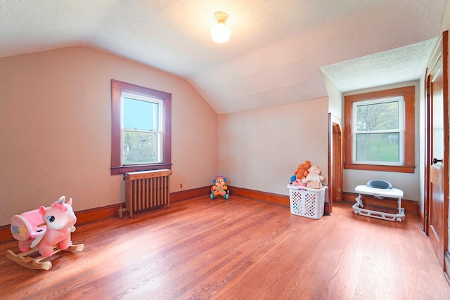 12 Sunset View Dr, West Nyack, NY 10994 - bonus room featuring baseboards, a textured ceiling, radiator, lofted ceiling, and light wood finished floors