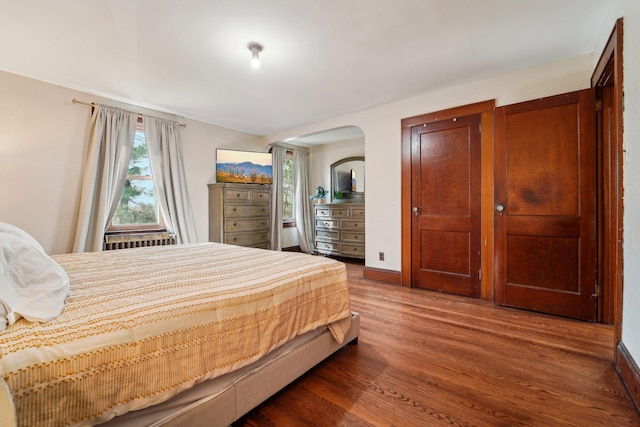 12 Sunset View Dr, West Nyack, NY 10994 - bedroom featuring arched walkways, wood finished floors, radiator, and multiple windows