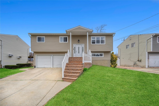 bi-level home featuring a garage, a front yard, and concrete driveway